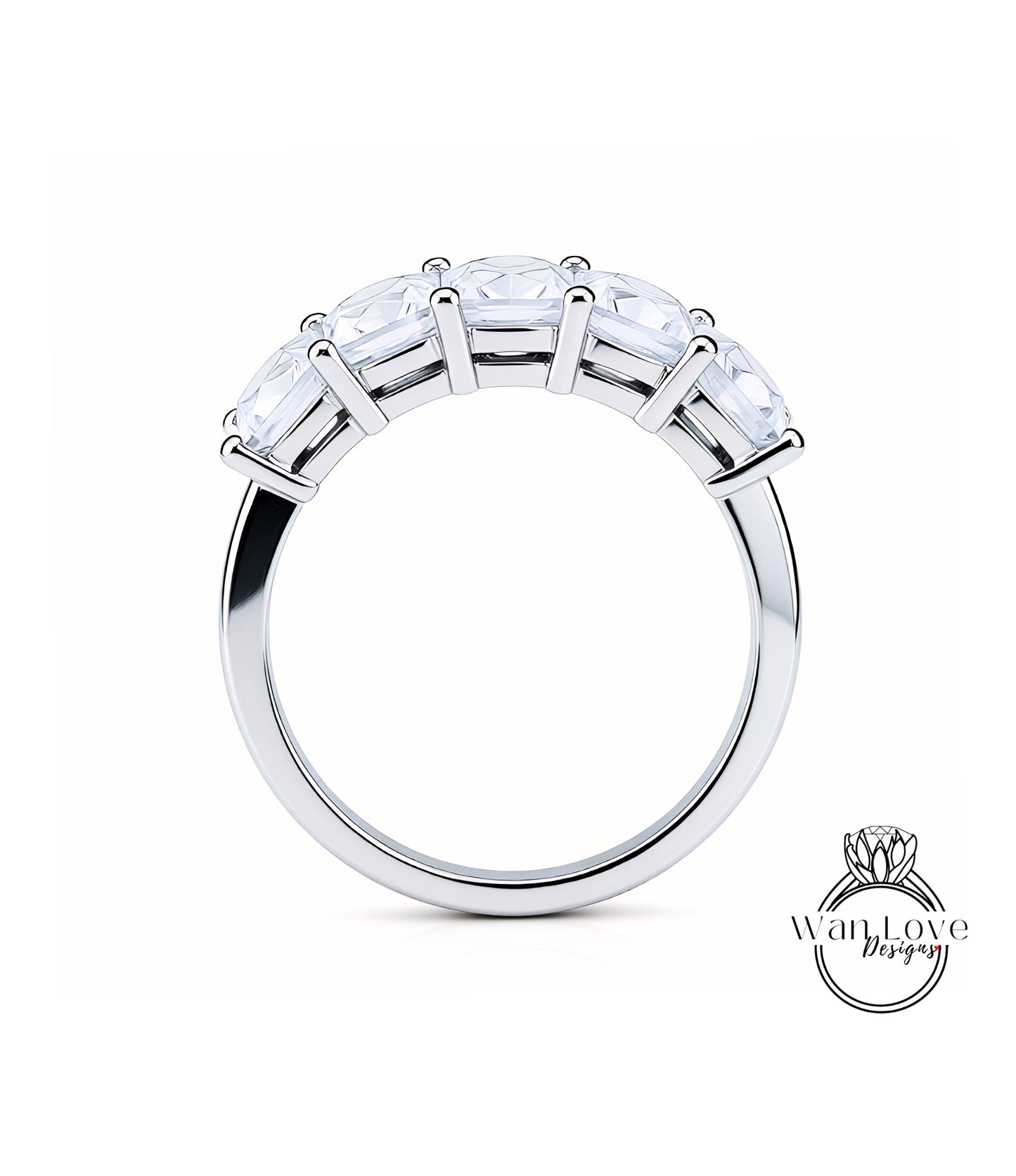 A silver ring with a row of clear gemstones on the band.