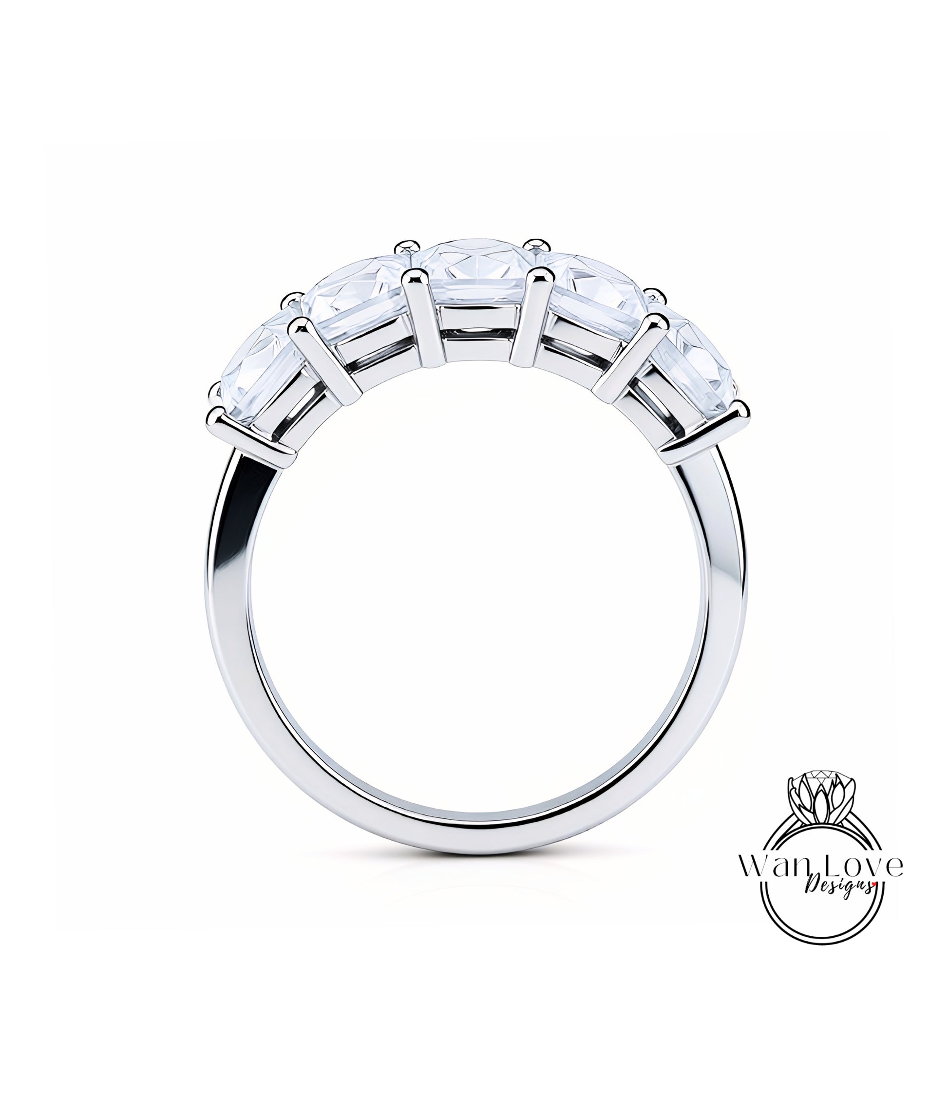 A silver ring with a row of clear gemstones on the band.