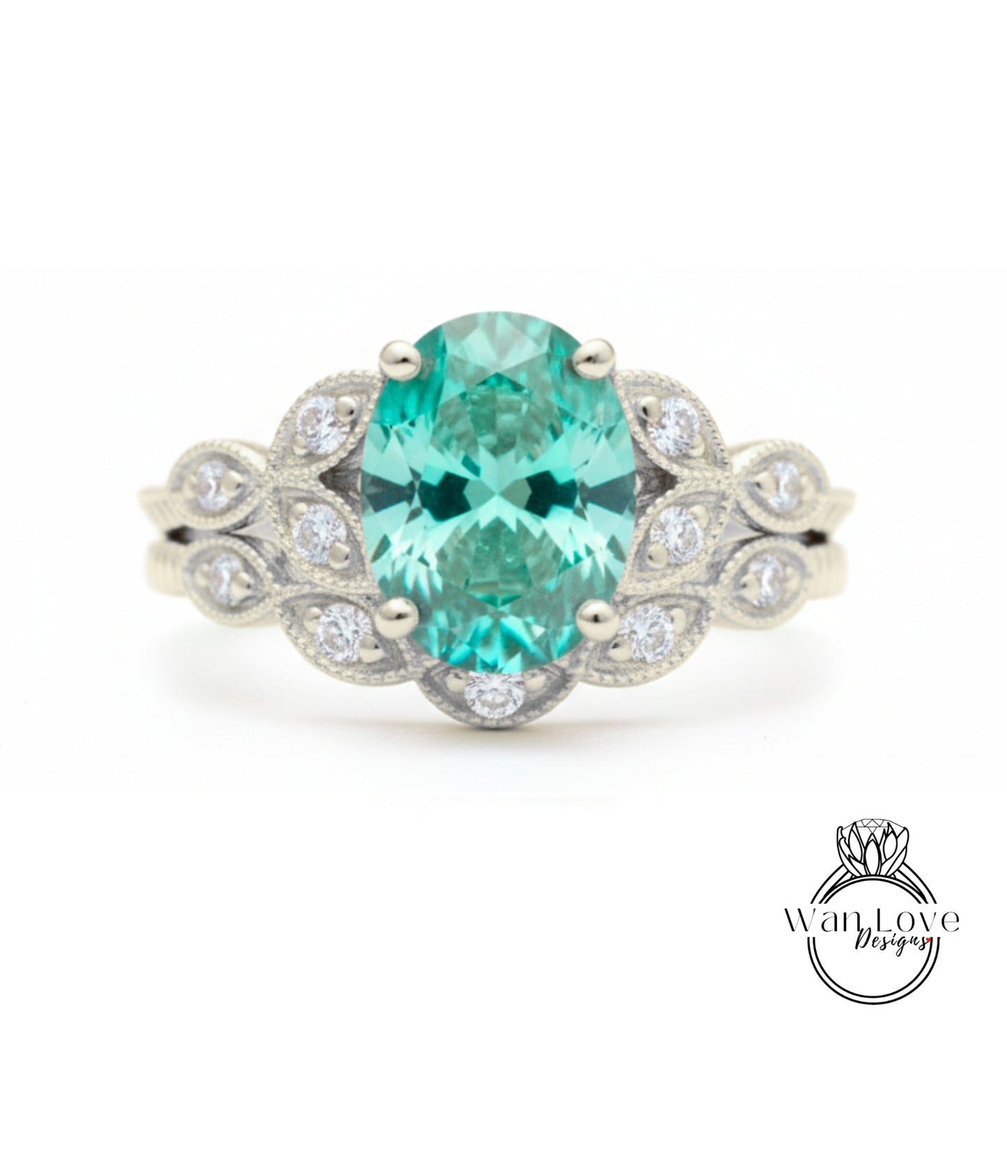 A silver ring with a large oval-shaped gemstone, surrounded by smaller diamonds, set in a decorative band.