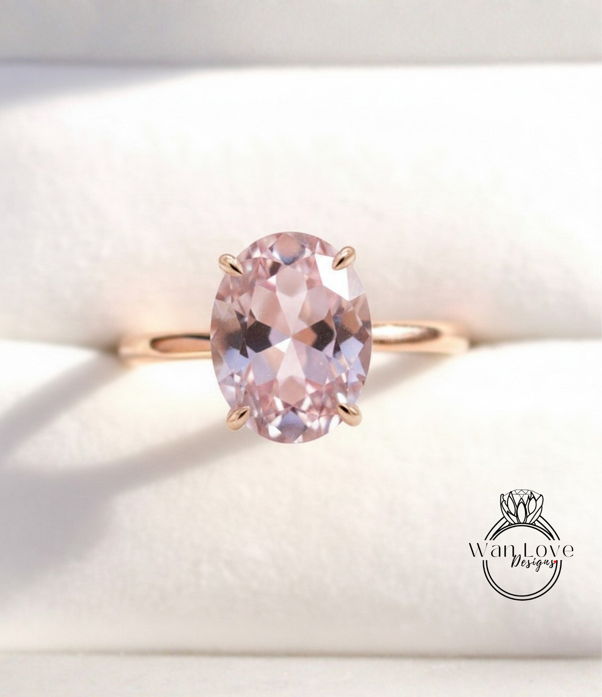 A gold ring with a large oval-shaped pink gemstone set in the center.