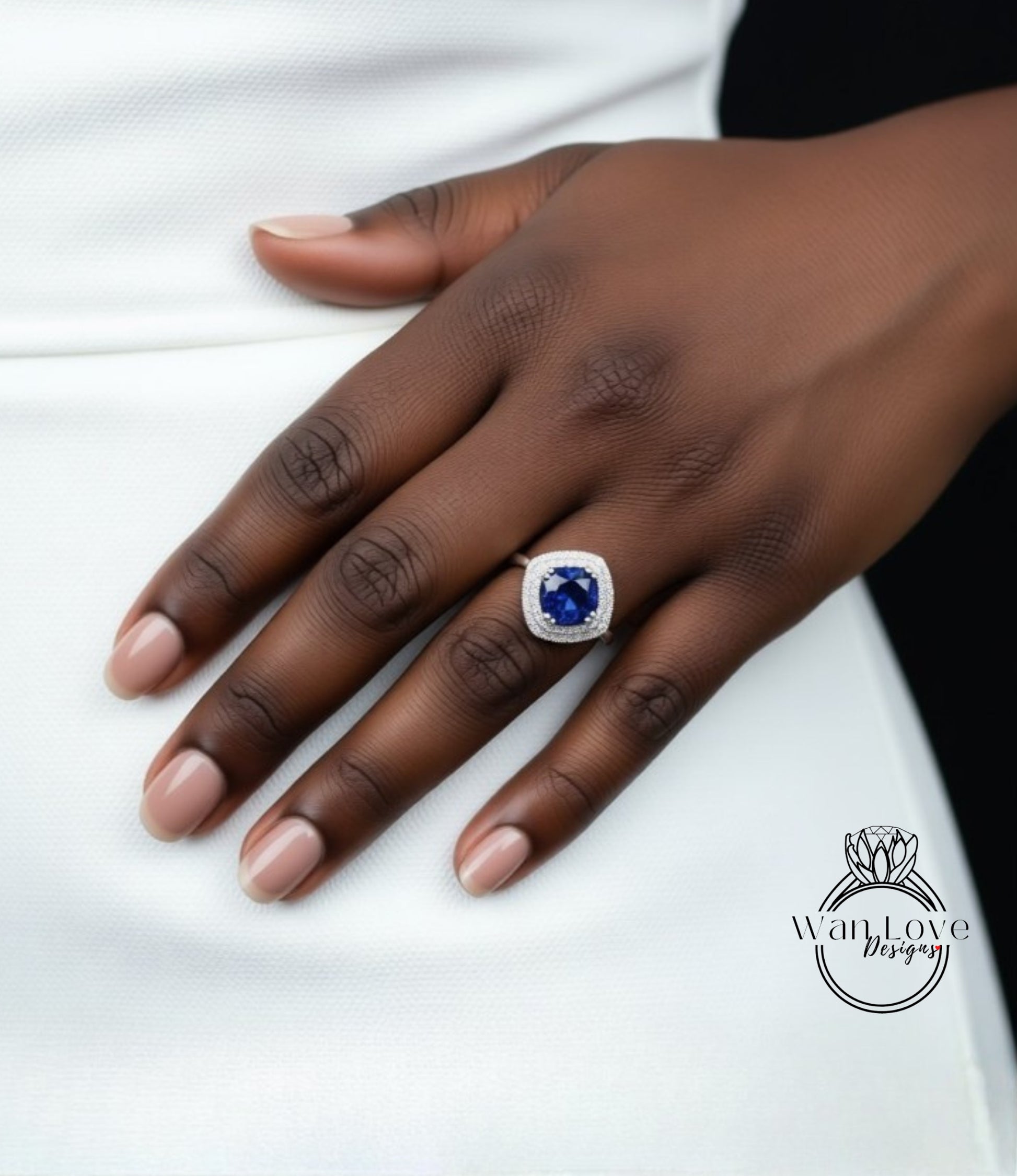 A close-up of a hand wearing a ring with a large blue gemstone.
