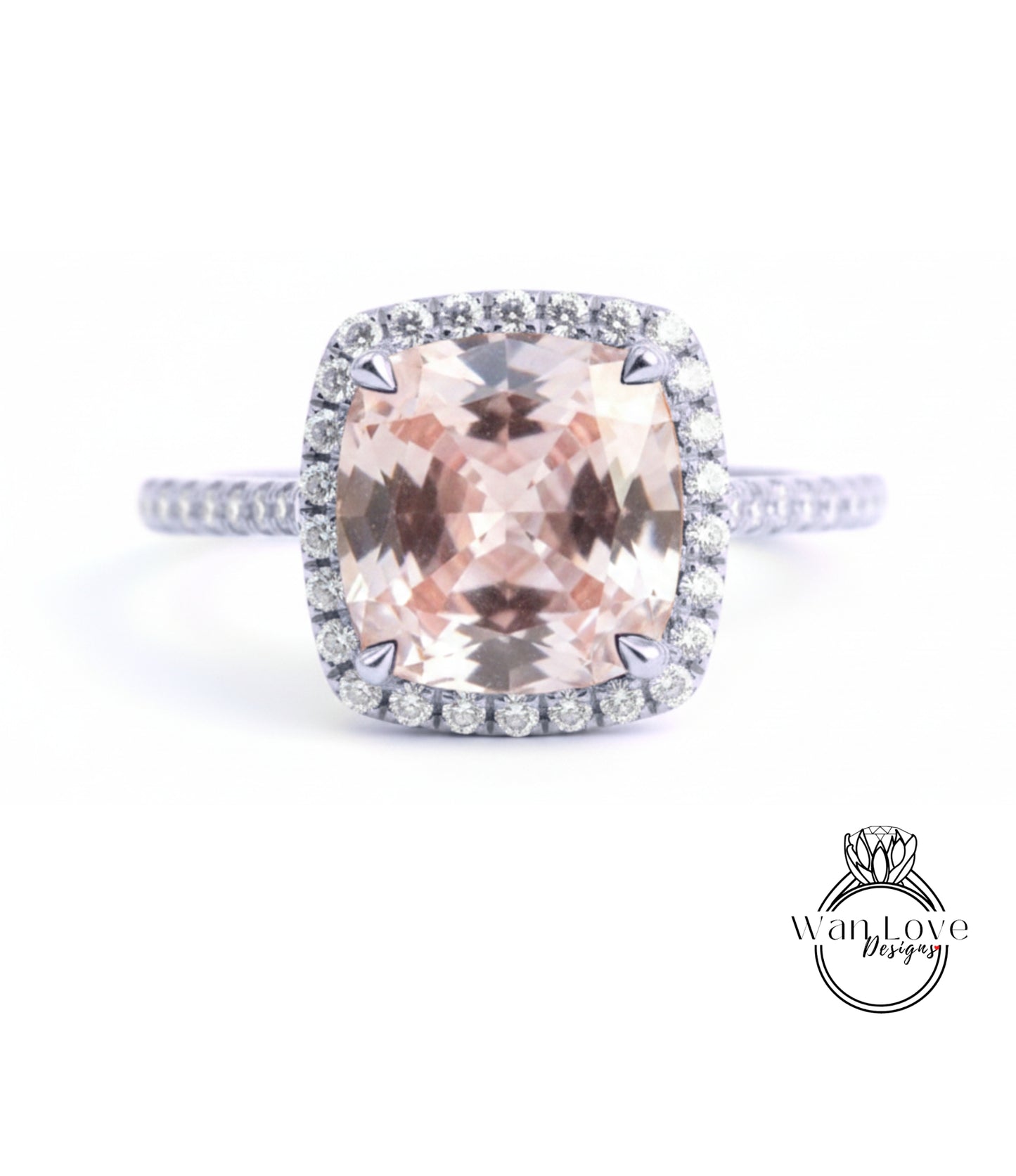 A large, pink gemstone ring with a halo of smaller diamonds around the center stone.