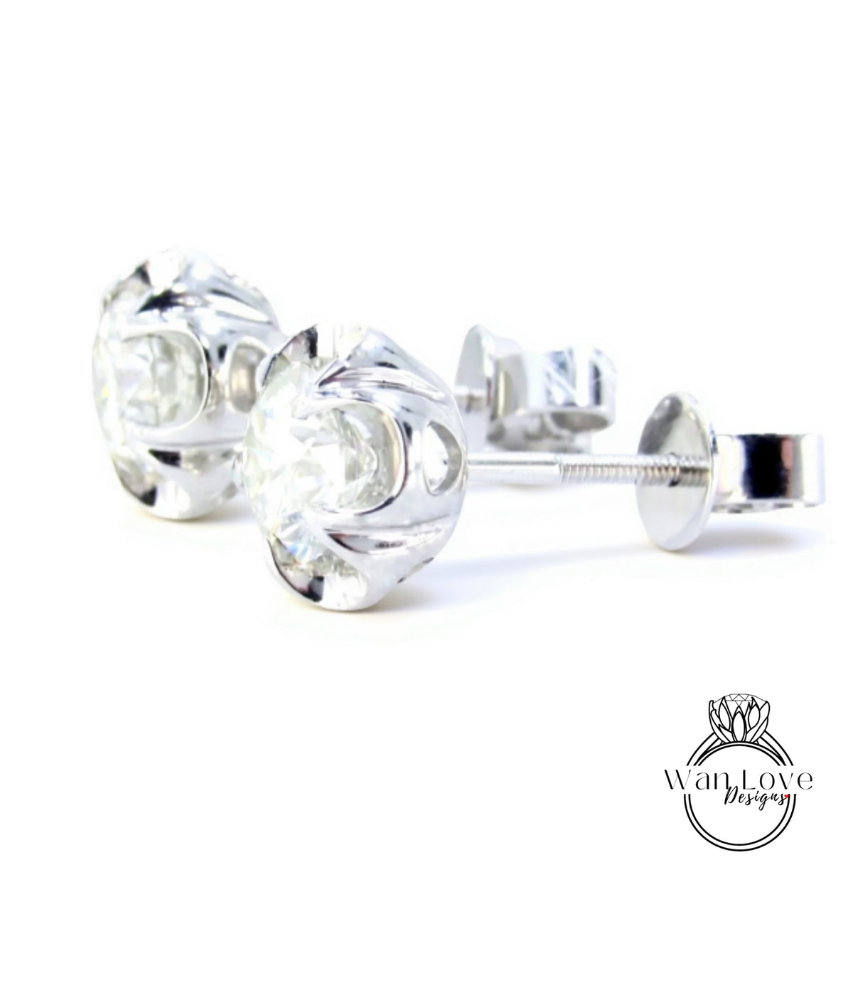 A pair of elegant silver earrings with clear gemstones, resting on a white background.