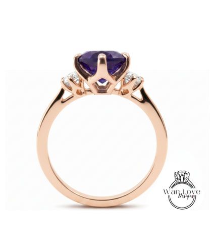 A gold ring with a large purple gemstone set in the center, surrounded by smaller diamonds.