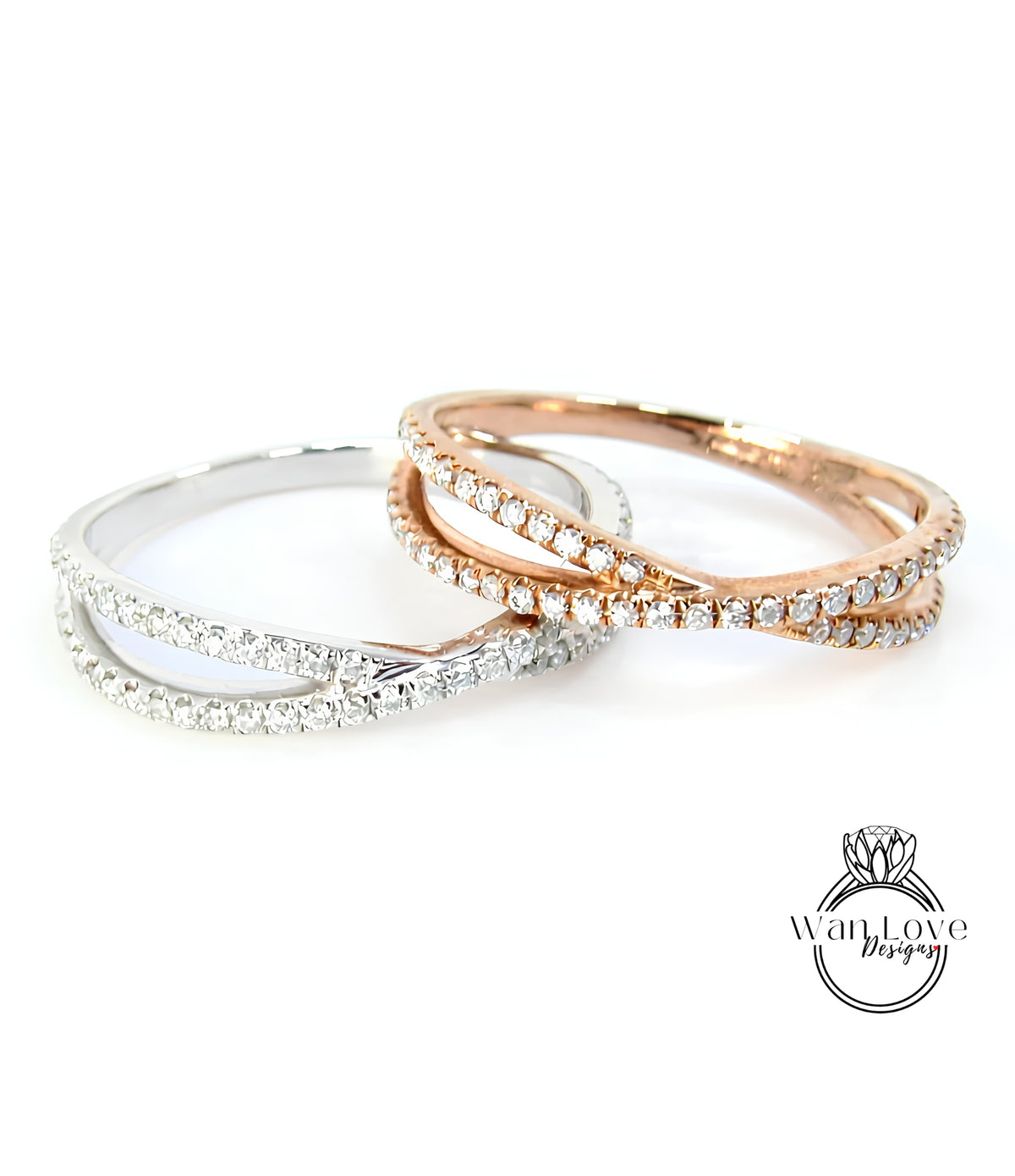 Two rings with diamonds set in a cross-over design, one silver and one gold.
