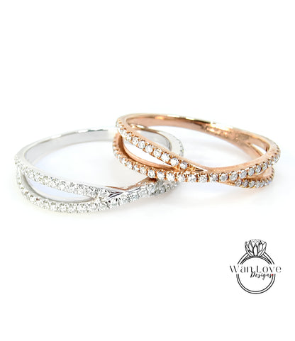 Two rings with diamonds set in a cross-over design, one silver and one gold.