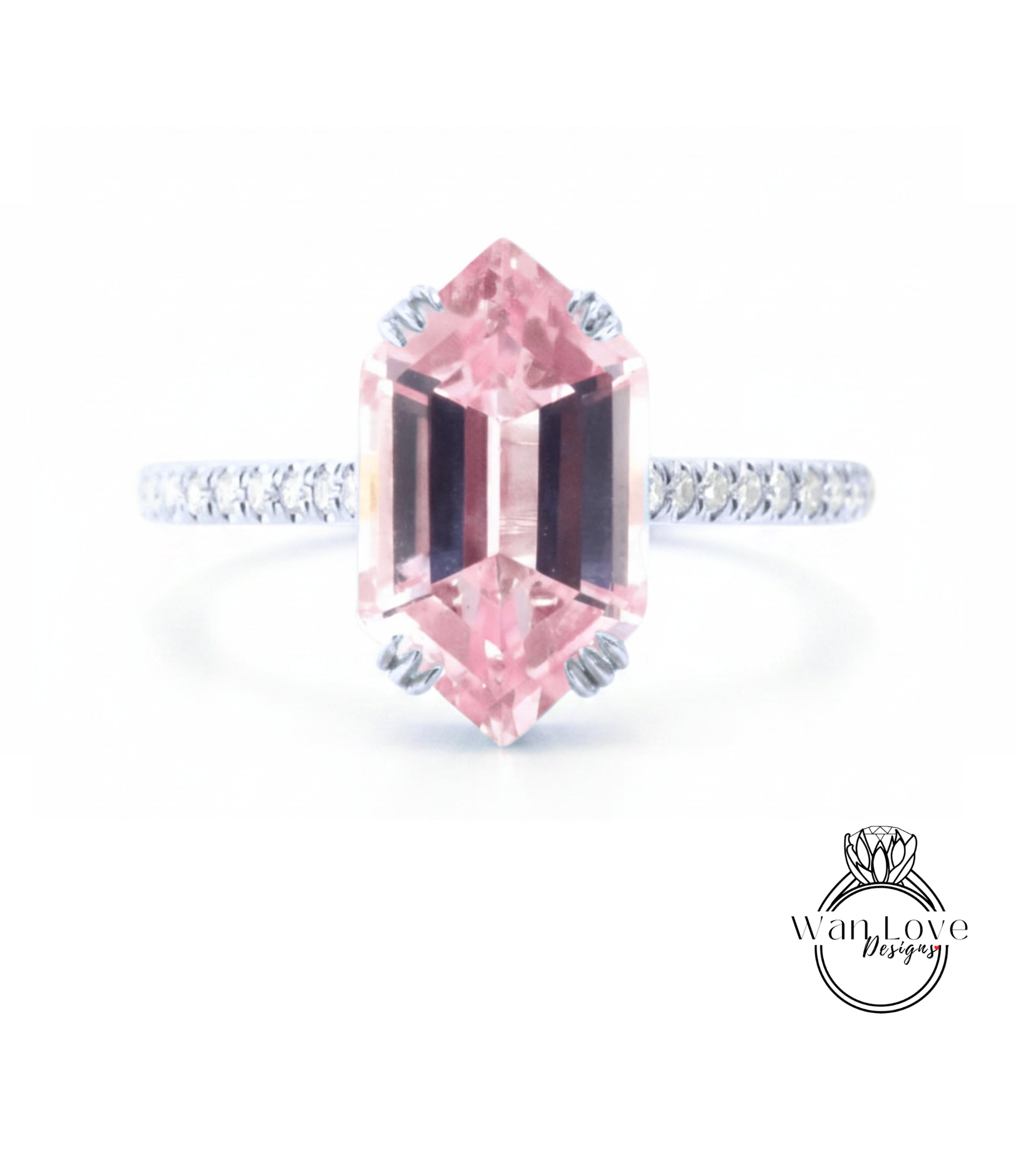 A pink gemstone engagement ring with a diamond band and a logo for "Wanted Love Designs" in the bottom right corner.