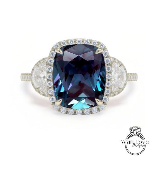 A stunning engagement ring with a large, deep blue gemstone set in a halo of smaller diamonds, surrounded by a delicate band of white diamonds.