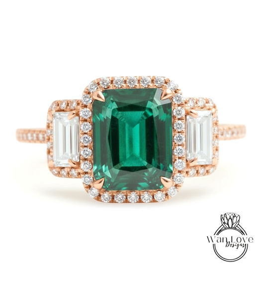 A rose gold ring with a large, green gemstone at the center, surrounded by smaller diamonds.