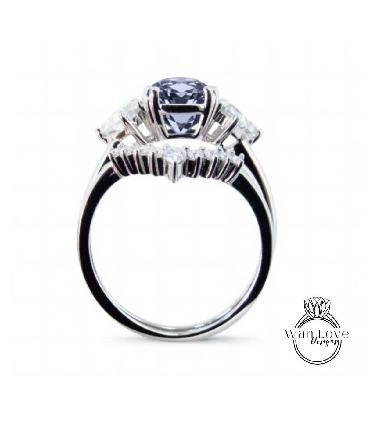 A silver ring with a large blue gemstone, possibly a diamond, set in the center.