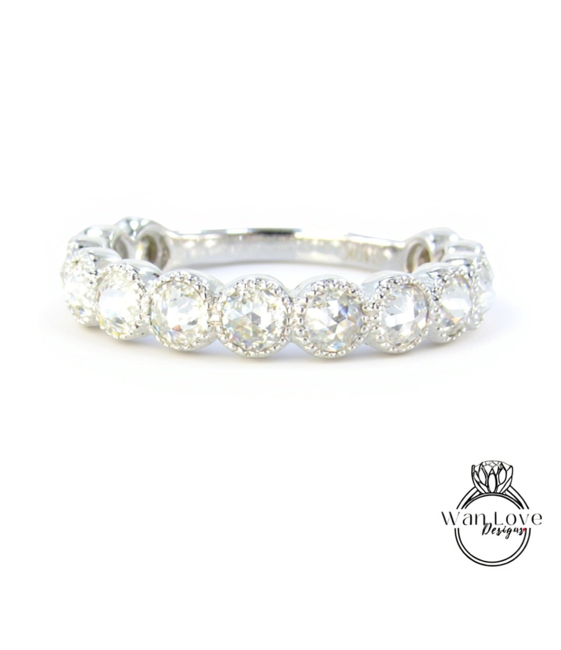 A close-up view of a diamond ring with a row of round diamonds set in a silver band.