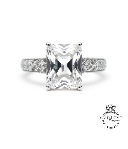 A diamond engagement ring with a large, clear gemstone set in a silver band.