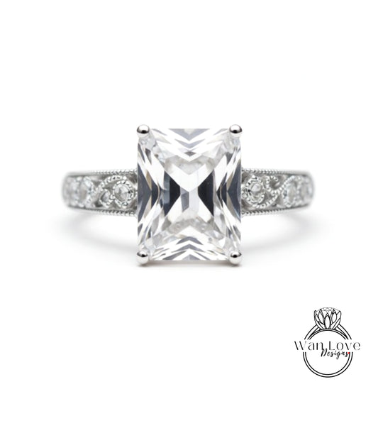 A diamond engagement ring with a large, clear gemstone set in a silver band.