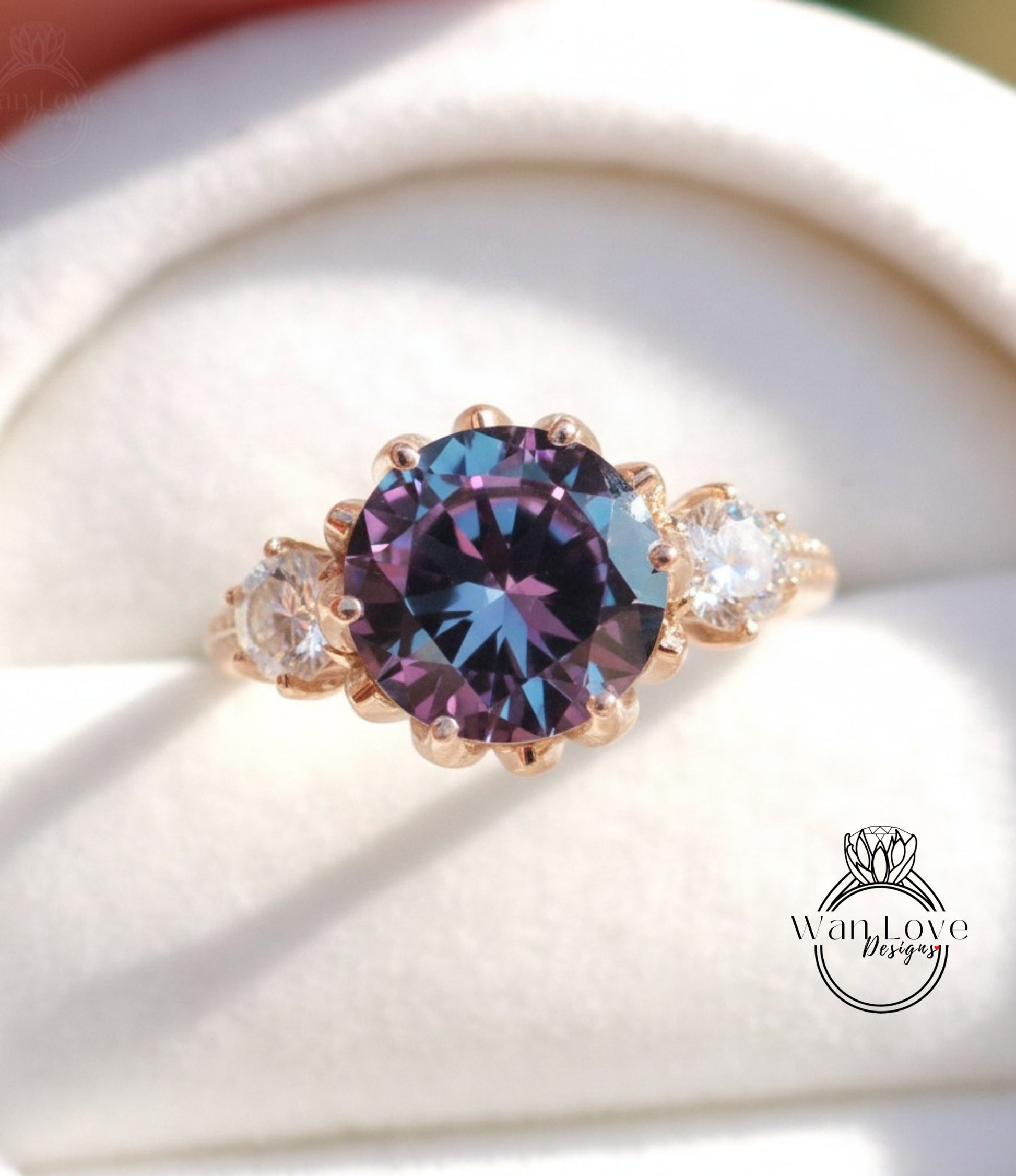 A close-up image of a gold ring with a large purple gemstone, showcasing the intricate details and craftsmanship of the jewelry.