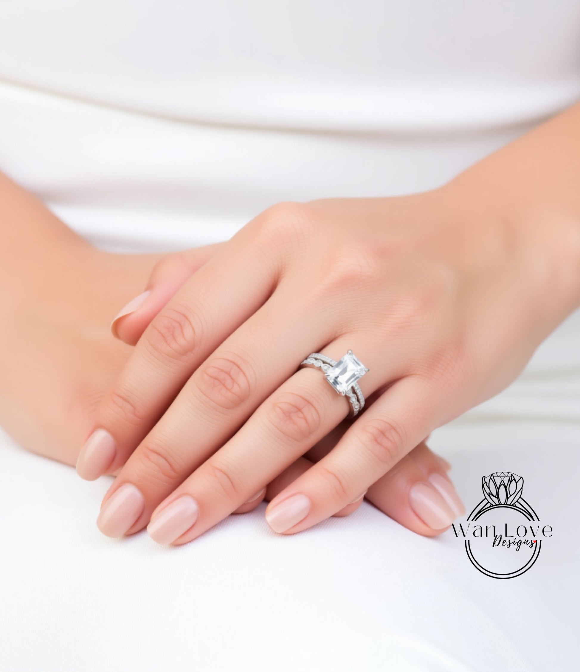 A close-up of a person's hand wearing a diamond engagement ring.