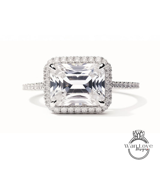 A large, square-cut diamond ring with a halo of smaller diamonds around the center stone.