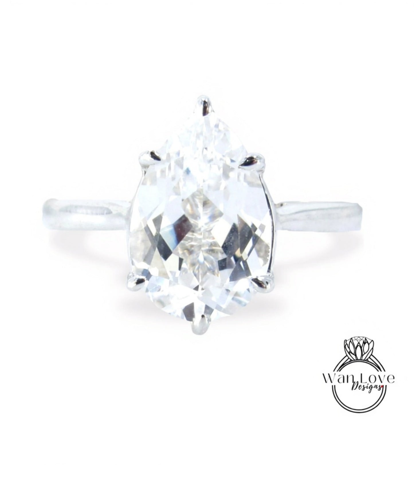 A close-up view of a diamond engagement ring with a large, clear gemstone set in a silver band.