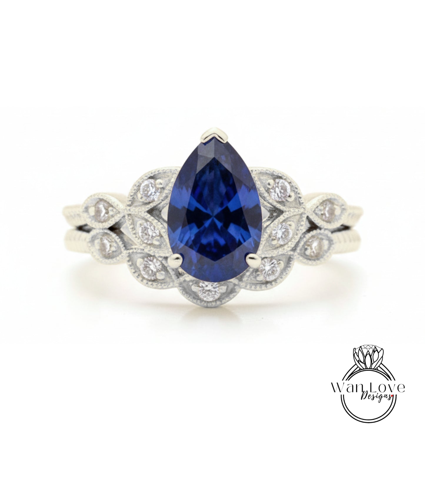 A close-up of a silver ring with a large blue gemstone, likely a sapphire, surrounded by smaller diamonds.