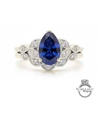 A close-up of a silver ring with a large blue gemstone, likely a sapphire, surrounded by smaller diamonds.