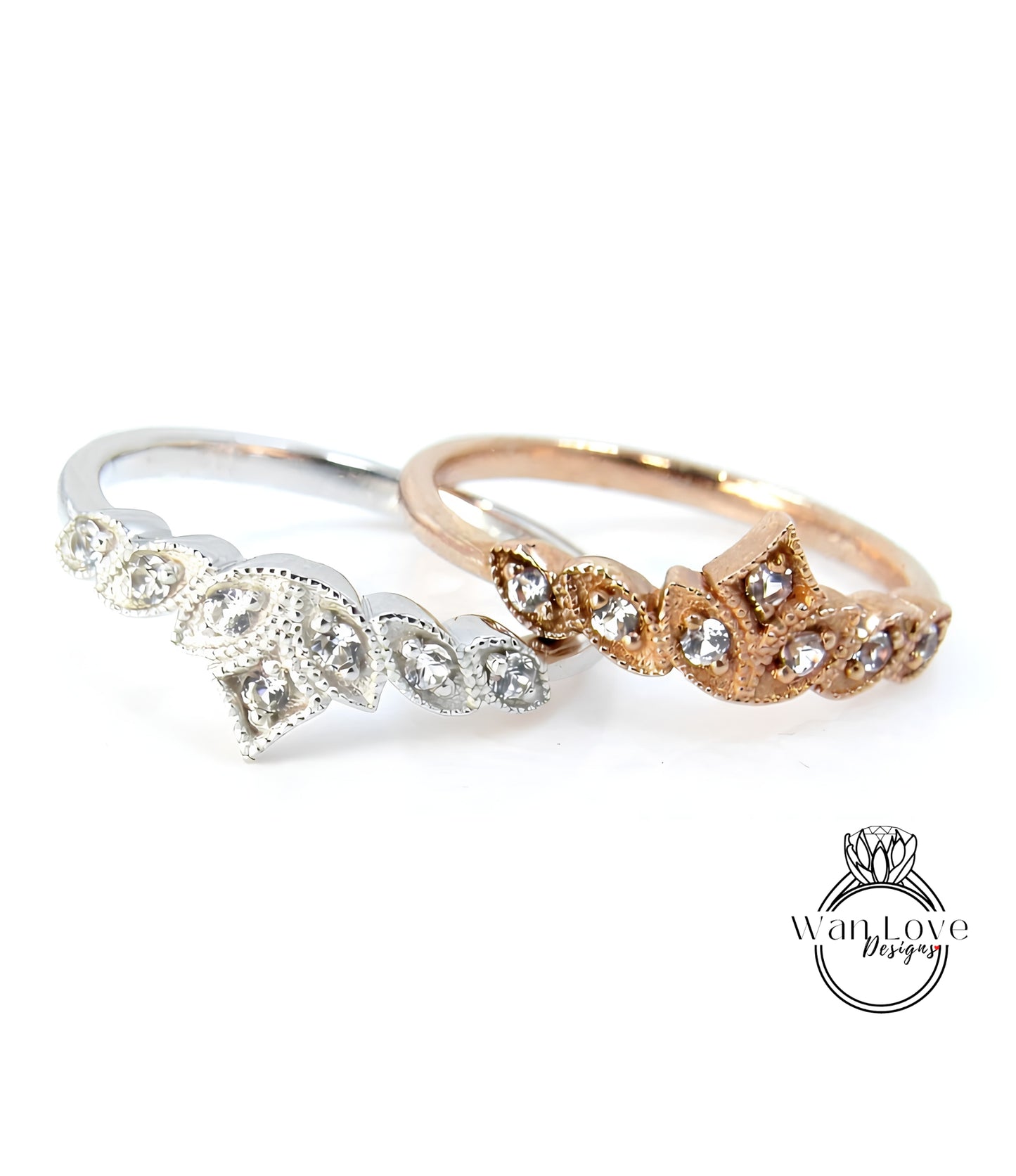 Two rings with diamond-encrusted designs are displayed against a white background.