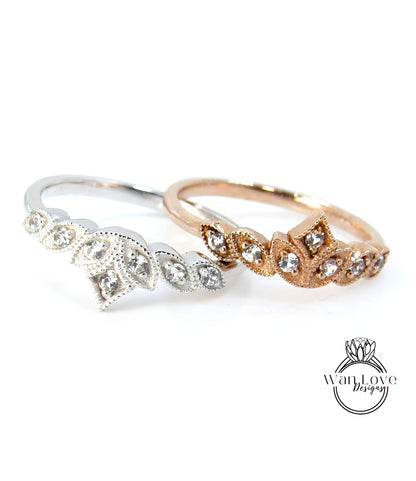 Two rings with diamond-encrusted designs are displayed against a white background.