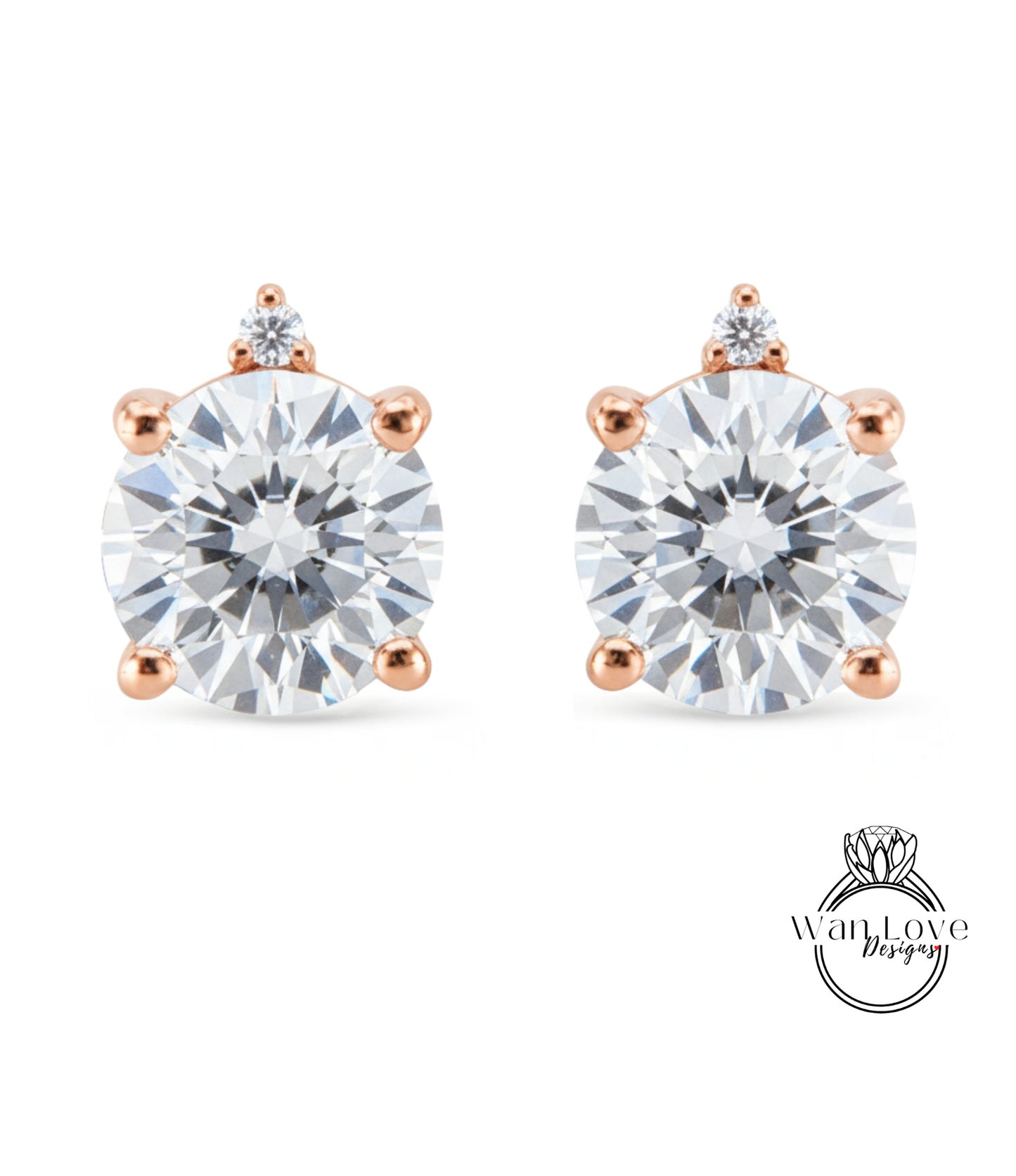 two diamond earrings with a large, clear gemstone set in a rose gold-colored metal.