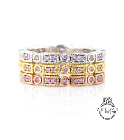 A close-up view of a ring with multiple layers of rings, each adorned with a small purple gemstone.