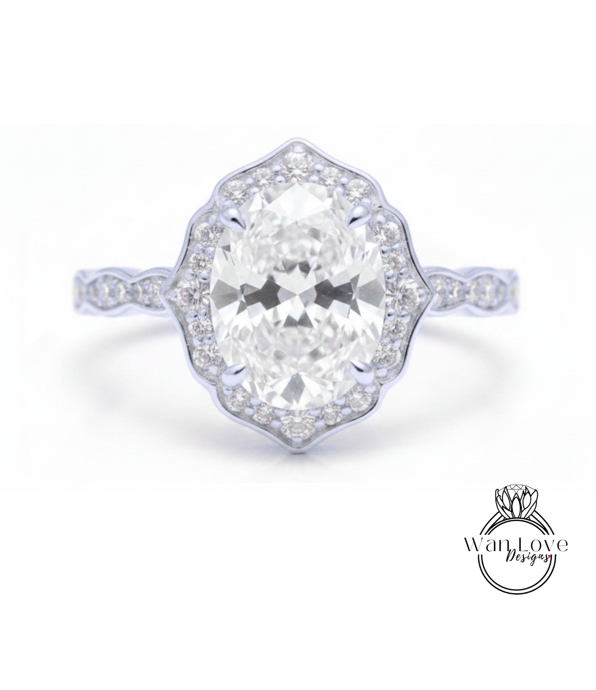 A close-up of a diamond engagement ring with a large oval-shaped diamond set in a halo of smaller diamonds.