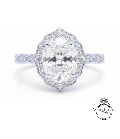 A close-up of a diamond engagement ring with a large oval-shaped diamond set in a halo of smaller diamonds.