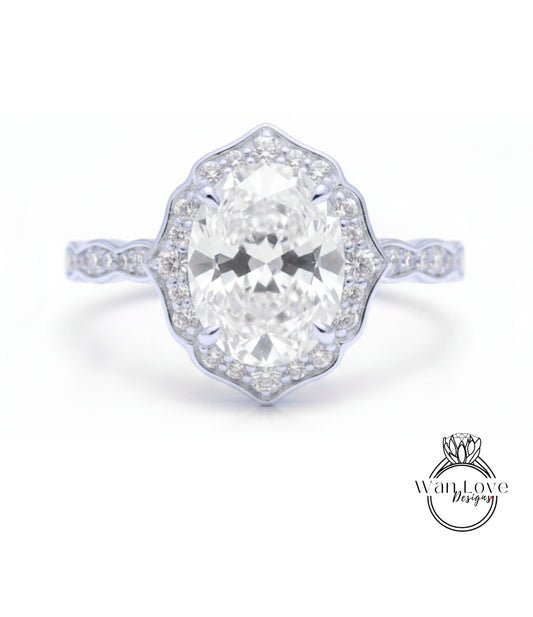 A close-up of a diamond engagement ring with a large oval-shaped diamond set in a halo of smaller diamonds.