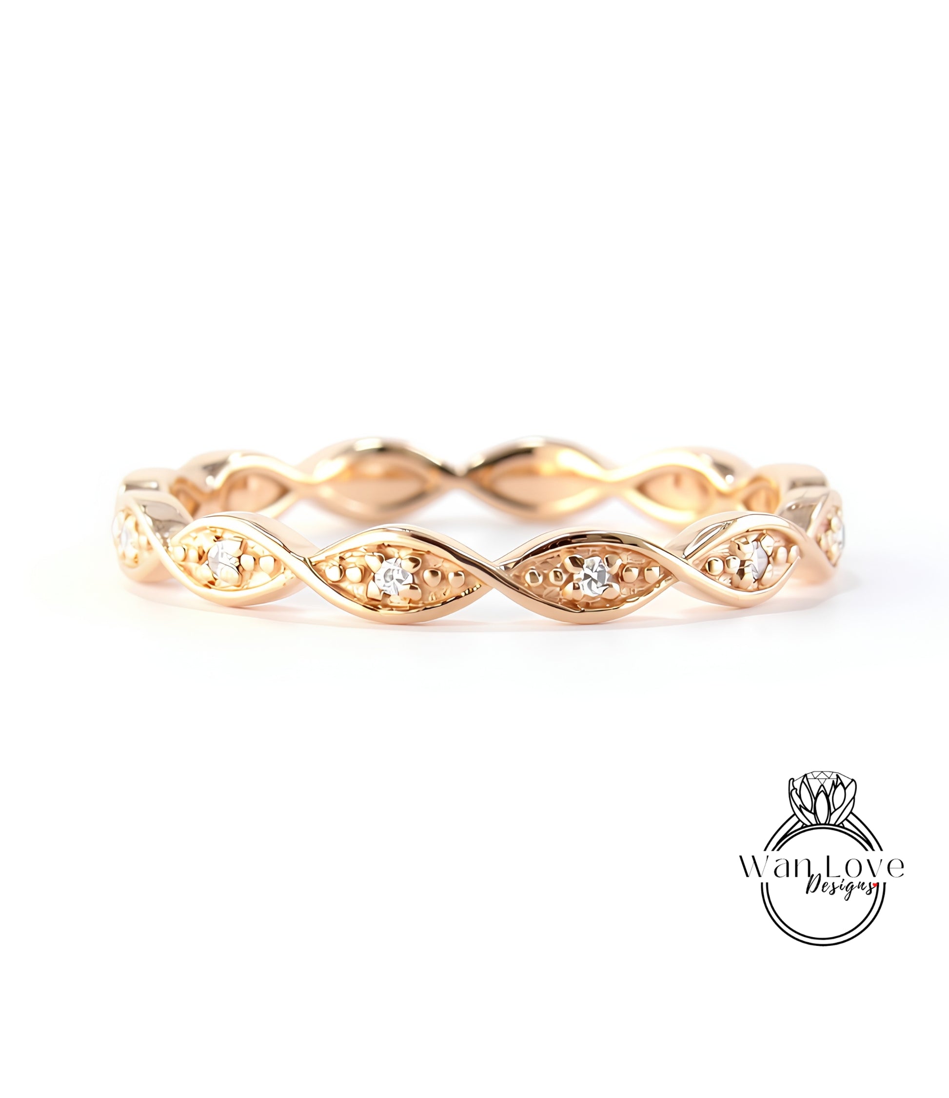 A gold ring with a twisted design and small diamonds set in the center.