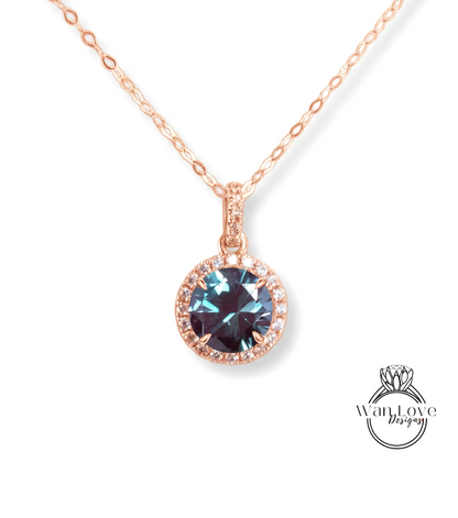 A necklace with a large blue gemstone pendant, which appears to be a sapphire or similar blue gemstone.