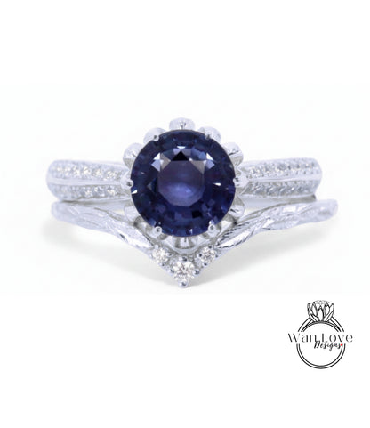 A close-up view of a silver ring with a large blue gemstone at the center, surrounded by smaller diamonds.