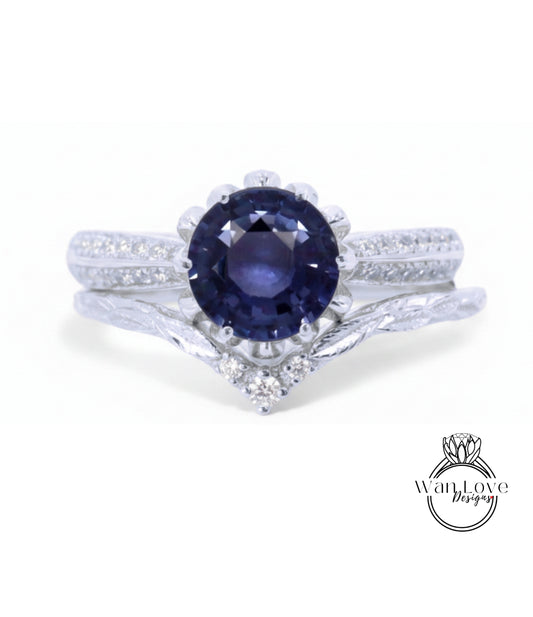 A close-up view of a silver ring with a large blue gemstone at the center, surrounded by smaller diamonds.