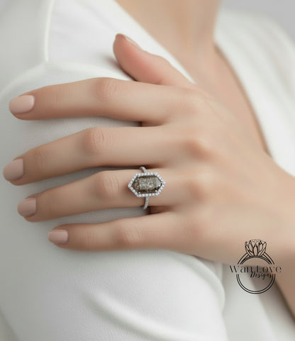 A close-up of a person's hand wearing a diamond ring on the ring finger.