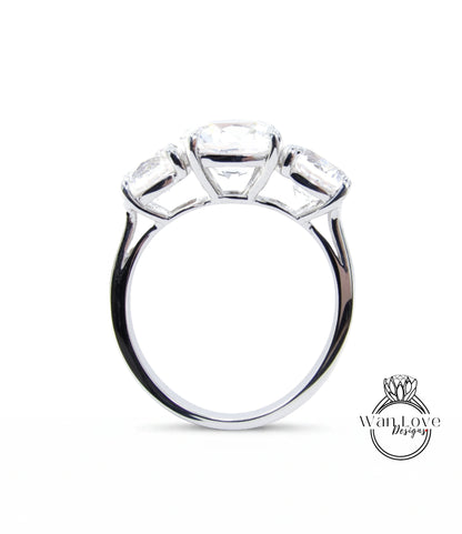 A silver ring with three large diamonds set in the center.