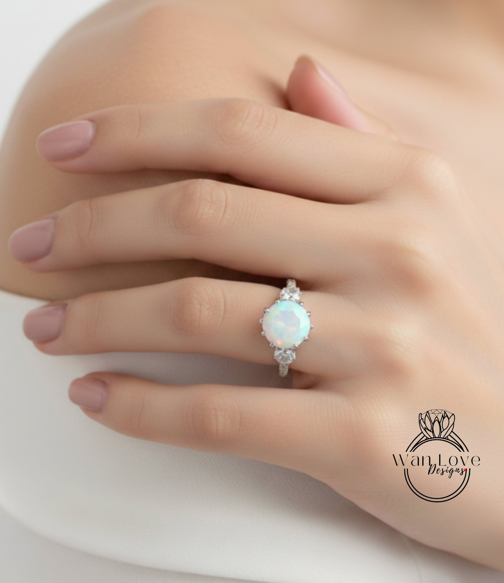 A close-up of a person's hand wearing a ring with a large, round opal stone.