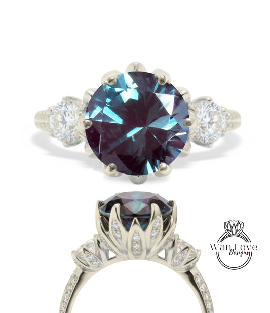 a silver ring with a large blue gemstone, likely a sapphire, set in a decorative floral design.