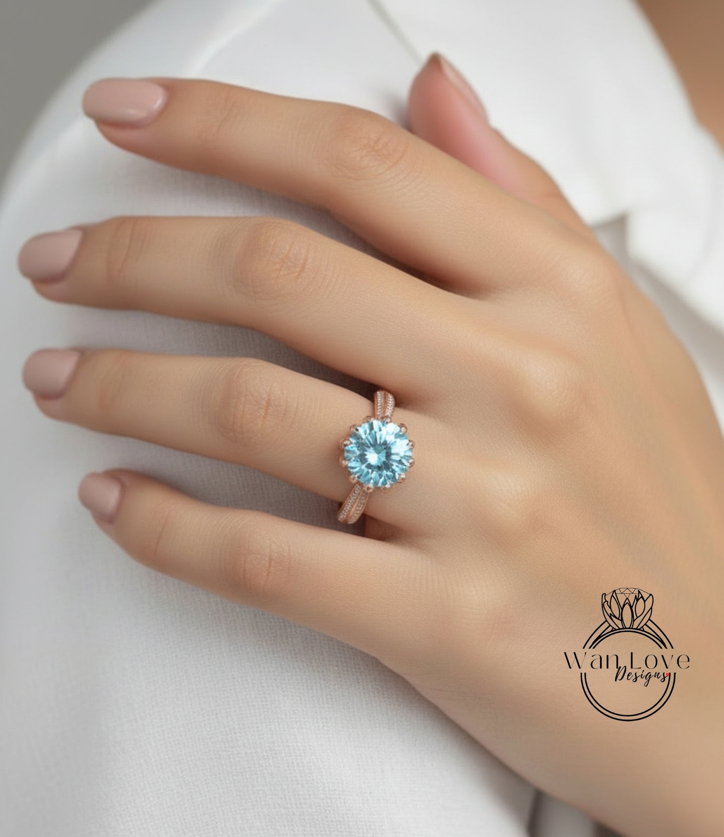 A close-up of a person's hand wearing a gold ring with a large blue gemstone.