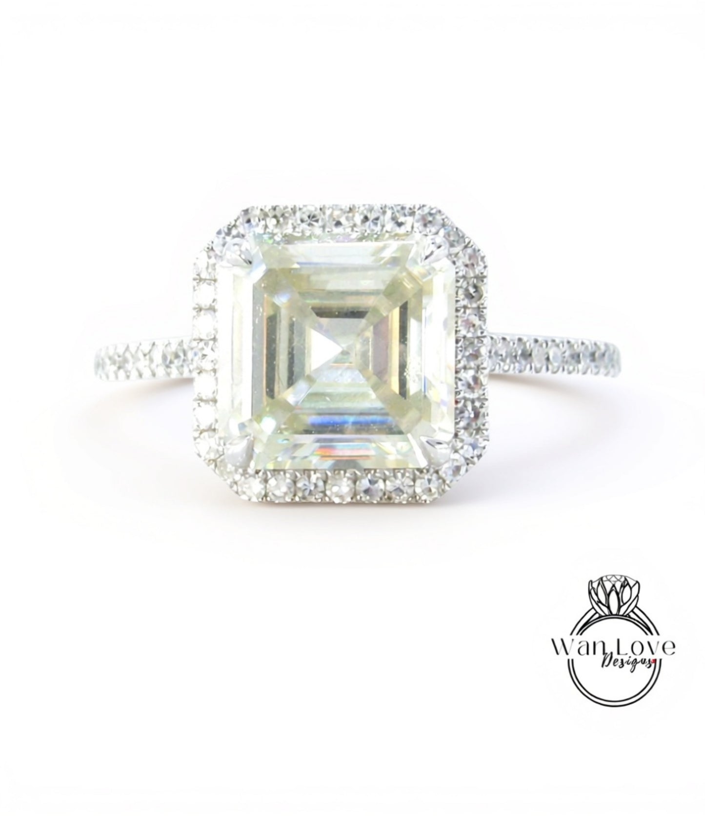 A large, square-cut diamond engagement ring with a halo of smaller diamonds around the center stone.