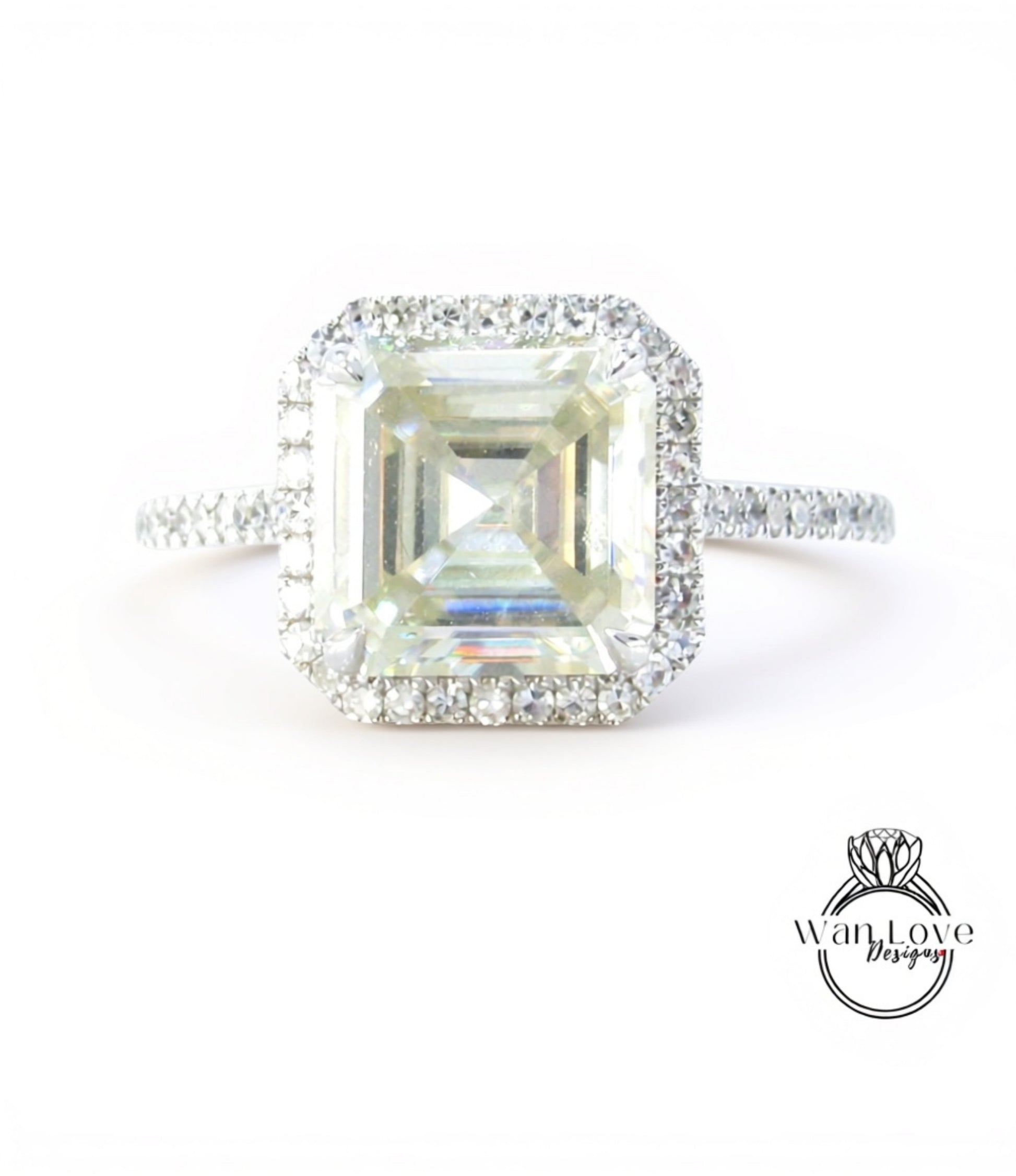 A large, square-cut diamond engagement ring with a halo of smaller diamonds around the center stone.