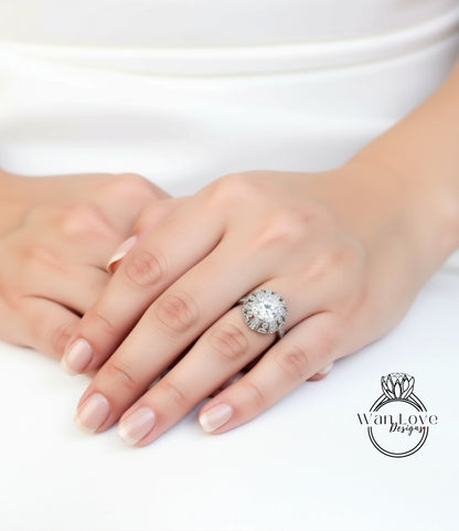 A close-up of a person's hand wearing a large, ornate ring with a large central stone surrounded by smaller stones.