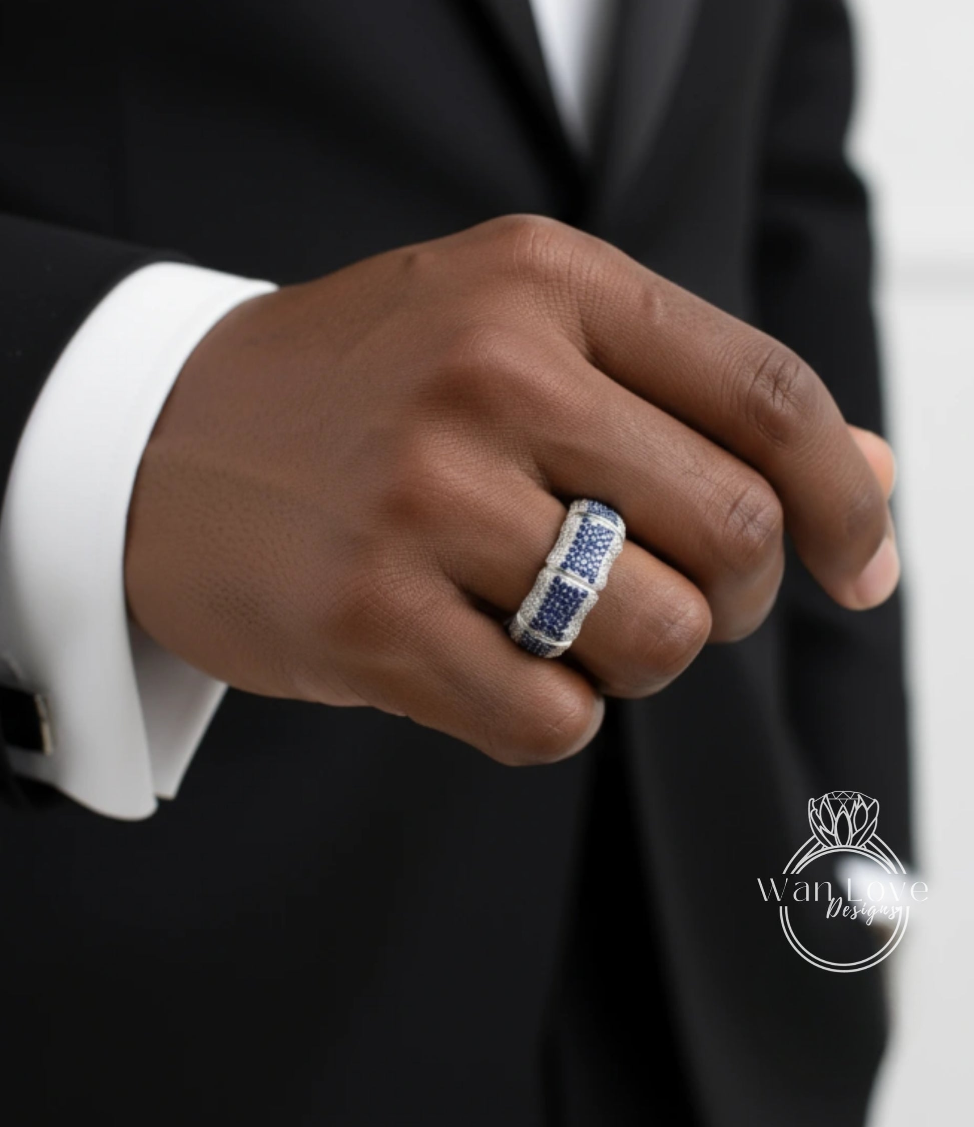 A close-up of a person's hand wearing a ring with a blue and white gemstone.