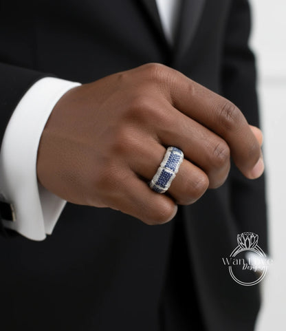 A close-up of a person's hand wearing a ring with a blue and white gemstone.