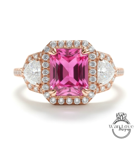 A pink gemstone engagement ring with a halo of diamonds around it, showcasing the ring's intricate design and sparkling gemstones.