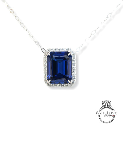 A necklace with a large blue gemstone, possibly a sapphire, set in a diamond-encrusted frame.