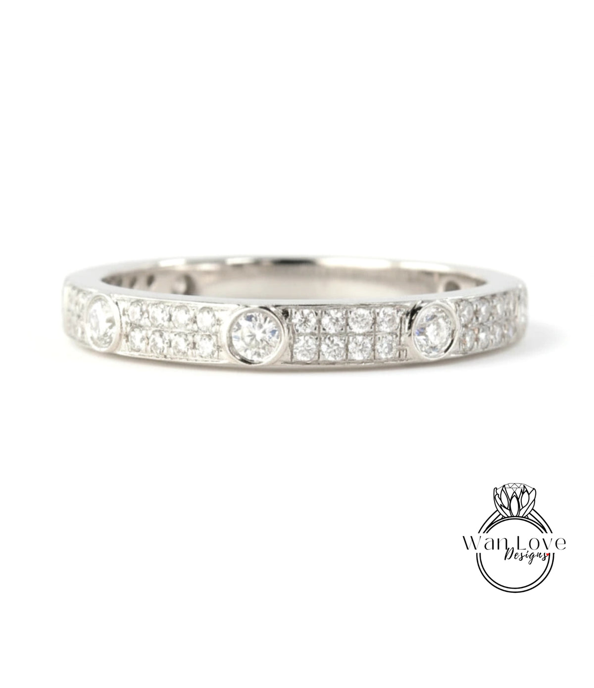 A silver band ring with a row of small diamonds set in the center.
