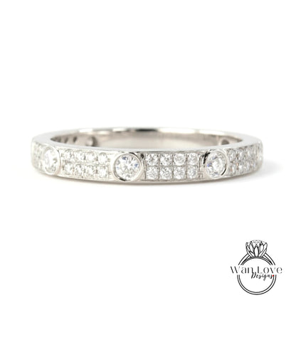A silver band ring with a row of small diamonds set in the center.