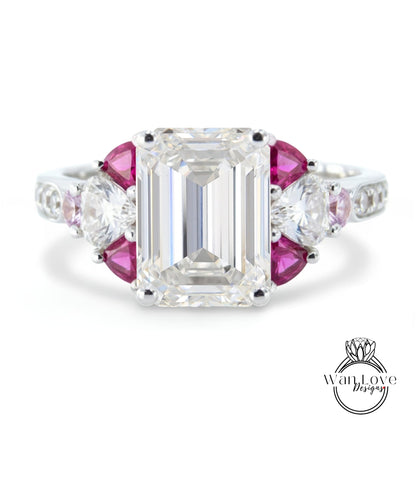 A stunning diamond engagement ring with a large, brilliant-cut diamond surrounded by smaller, round-cut diamonds and a combination of pink and clear gemstones.