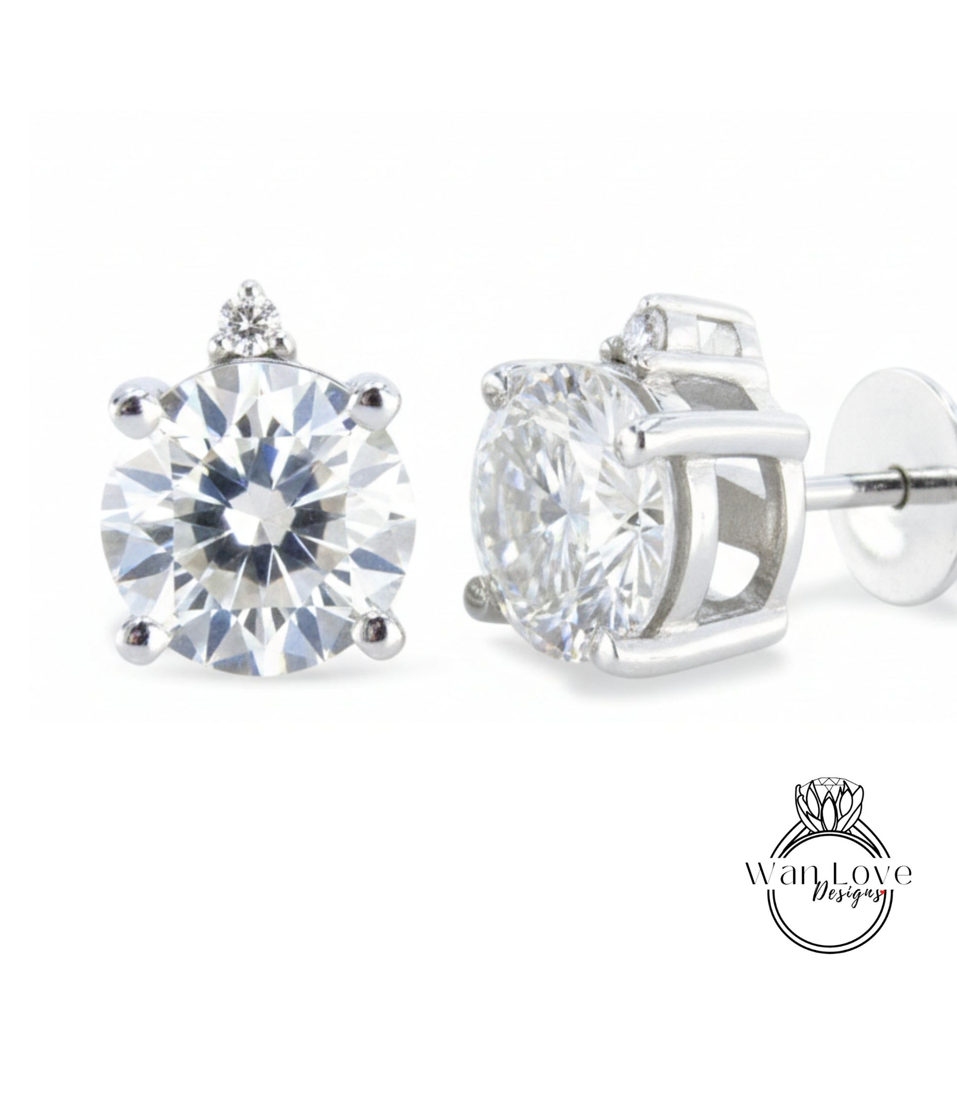 A pair of elegant diamond earrings with a large, brilliant-cut diamond set in a silver-toned metal frame.